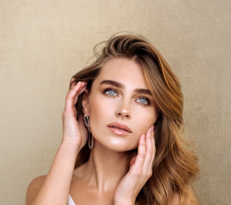 Beautiful model with clear skin touching face